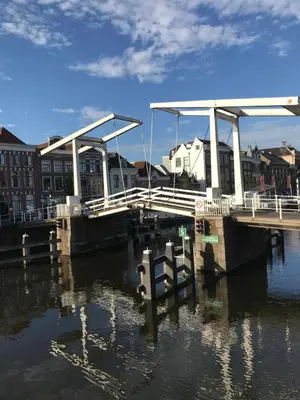 a dock in the water next to some buildings at De Haarlemse Logeerkamer in Haarlem