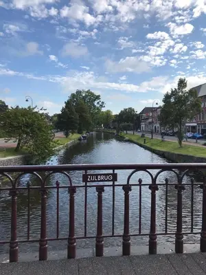 a river with a sign that reads alums at De Haarlemse Logeerkamer in Haarlem