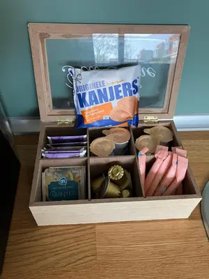 a wooden box filled with items on a table at De Haarlemse Logeerkamer in Haarlem