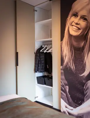 a painting of a woman is in a closet at B&B Bardot in Purmerend
