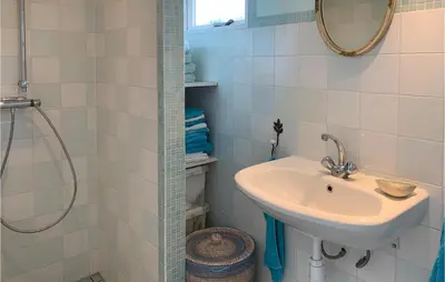 a bathroom with a sink and a shower at Zeemeermin in Egmond aan Zee