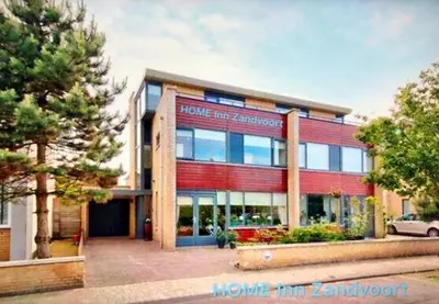 a building with a sign on the front of it at Home Inn Zandvoort the First Floor 4 Persons, 2 bedrooms, Free Parking! in Zandvoort