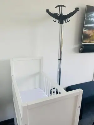 a room with a white crib and a stair case at Home Inn Zandvoort the First Floor 4 Persons, 2 bedrooms, Free Parking! in Zandvoort