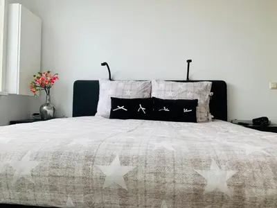 a bedroom with a bed with stars on it at Home Inn Zandvoort the First Floor 4 Persons, 2 bedrooms, Free Parking! in Zandvoort