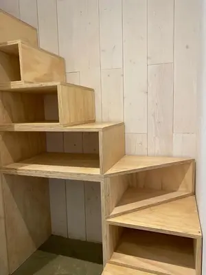 a shelf in a room with wooden shelves at Holiday home De Heer van Bergen in Bergen