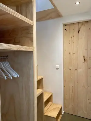 a room with wooden shelves and a closet at Holiday home De Heer van Bergen in Bergen