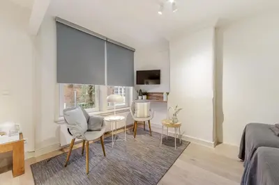 a bedroom with a bed and a table and chairs at Adam's Suite in Amsterdam