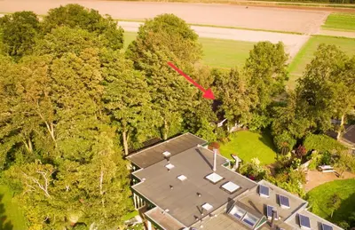 an aerial view of a house in the trees at Klein Langeveld in Noordwijkerhout