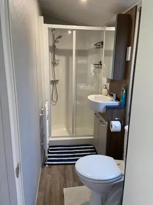 a bathroom with a shower and a toilet and a sink at Cheerful and relaxing chalet Viena(Park deHorn824) in Dirkshorn