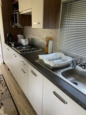 a kitchen with a sink and a counter top at Cheerful and relaxing chalet Viena(Park deHorn824) in Dirkshorn