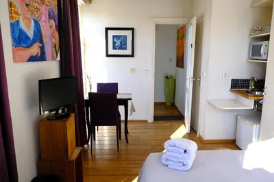 a room with a table with a television and a room with a tableablish at Eelhouse private studio in Amsterdam