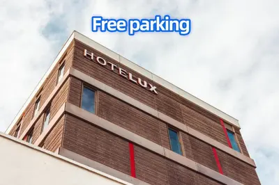 a sign on the top of a hotel building at HOTELUX Amsterdam Airport Hotel in Hoofddorp