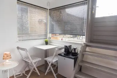 a kitchen with two chairs and a table and a window at HouseBoat next to AMSTEL in Amsterdam