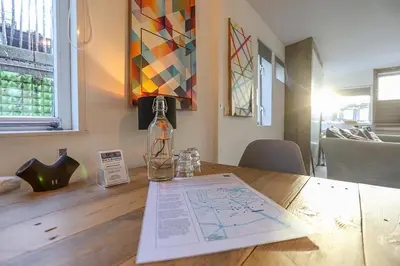 a table with a bottle and a paper on it at HouseBoat next to AMSTEL in Amsterdam