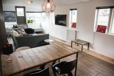 a living room with a table and a couch at HouseBoat next to AMSTEL in Amsterdam