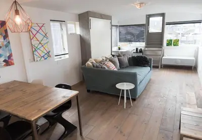 a living room with a couch and a table at HouseBoat next to AMSTEL in Amsterdam