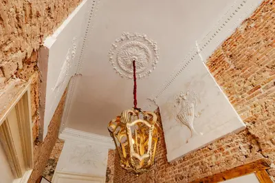 a mask hanging from the ceiling of a room at MAF Haarlem Boutique Hotel in Haarlem
