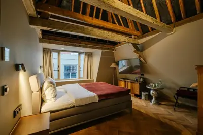 a bedroom with a large bed and a window at MAF Haarlem Boutique Hotel in Haarlem