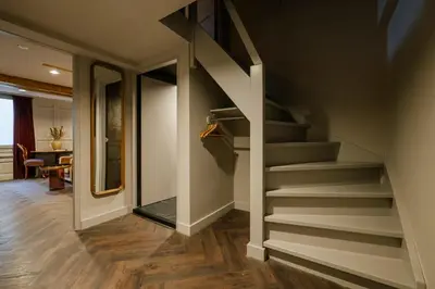 a staircase in a living room with a stair case at MAF Haarlem Boutique Hotel in Haarlem