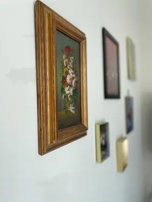 a painting of flowers on a white wall at Bed & Beach Amsterdam in Amsterdam