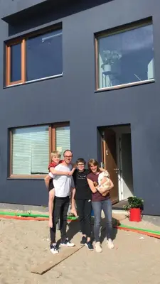 a group of people standing in front of a blue house at Bed & Beach Amsterdam in Amsterdam