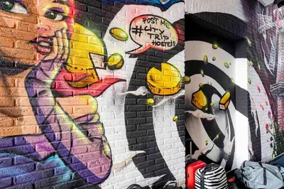 a wall with a painting of a woman on it at City Trip Hostels Amsterdam-Purmerend in Purmerend