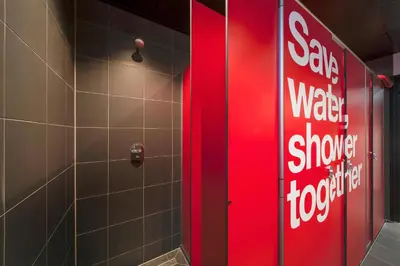 a shower stall with a red sign in a bathroom at City Trip Hostels Amsterdam-Purmerend in Purmerend