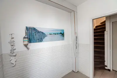 a white hallway with a picture on the wall at Seawave Studio in Zandvoort