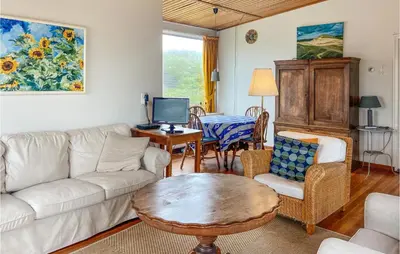 a living room with a couch and a table at Blaauburgh in Bergen aan Zee