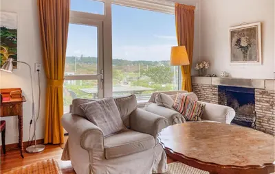 a living room with a table and chairs and a fireplace at Blaauburgh in Bergen aan Zee