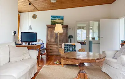 a living room with a white couch and a table at Blaauburgh in Bergen aan Zee