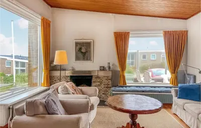 a living room with a couch and a fireplace at Blaauburgh in Bergen aan Zee