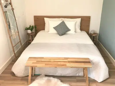 a bedroom with a bed with a wooden table at Time Out Beach House in Zandvoort