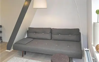 a couch in the corner of a living room at Duinviooltje 2 in Bergen aan Zee