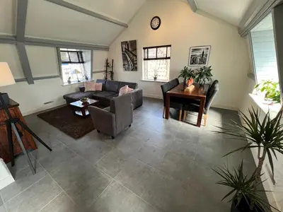 a living room with a couch and a table at Appartement Warmond in Warmond