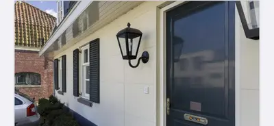 a door to a house with a light on it at Appartement Warmond in Warmond