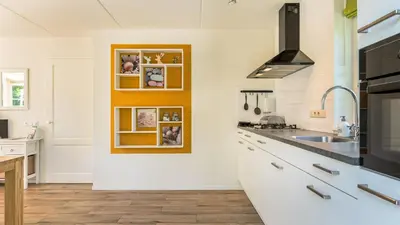 a kitchen with a sink and a counter top at Huisje Avondrood in Schoorl