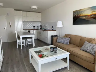a living room with a couch and a table at Droomvakanties Egmond Zeezicht in Egmond aan Zee
