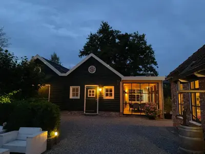 a house with its door open in the evening at Flora’s B&B in Landsmeer