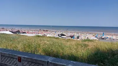 a beach with a large crowd of people at Zeelucht in Zandvoort