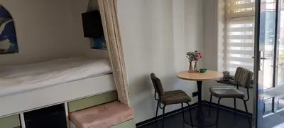 a small room with a table and a bed and a mirror at Zeelucht in Zandvoort