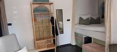 a room with a mirror next to a bed and a dog at Zeelucht in Zandvoort