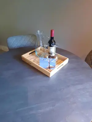 a tray with a bottle of wine on a table at Have a nice stay! - Souterrain Edelweiss in Noordwijk