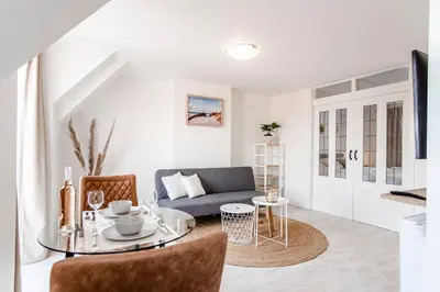 a living room with a couch and a table at Sand & Dunes Apartment in Zandvoort