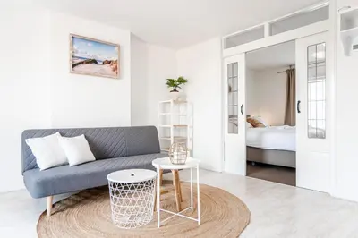 a living room with a couch and a table at Sand & Dunes Apartment in Zandvoort