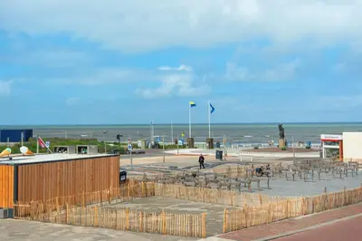 a seating area at the beach with the ocean in the background at Sand & Dunes Apartment in Zandvoort