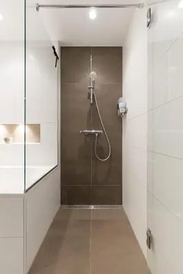 a shower in a bathroom with a glass door at Beach Villa & Studio in Zandvoort