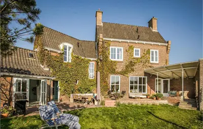 a large brick house with ivy growing on it at Zeevilla Duinhorst in Bergen aan Zee