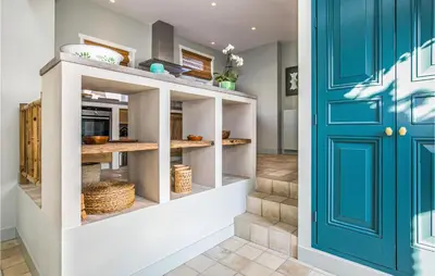 a kitchen with a blue door at Zeevilla Duinhorst in Bergen aan Zee
