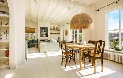 a dining room with a table and chairs at Zeevilla Duinhorst in Bergen aan Zee